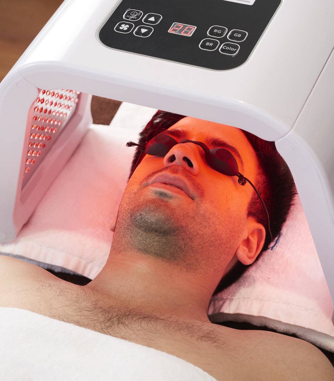 Omega Bright LED Light Therapy Device in use during red light skin treatment for men. Ideal for at-home 7-color skin rejuvenation and anti-aging care.